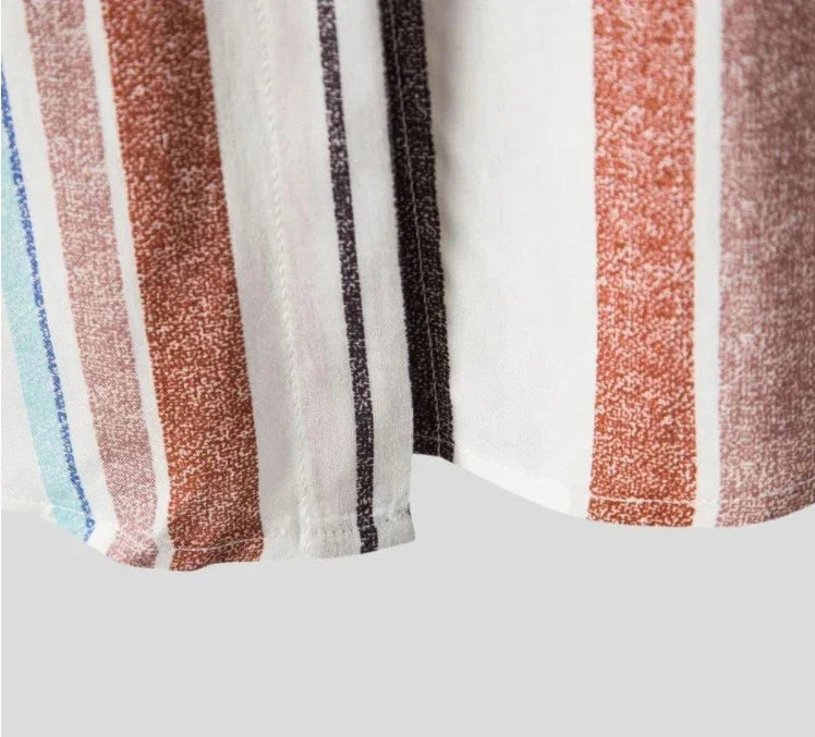 Close-up of fabric with vertical multicolor stripes in blue, brown, black, and white on a light background