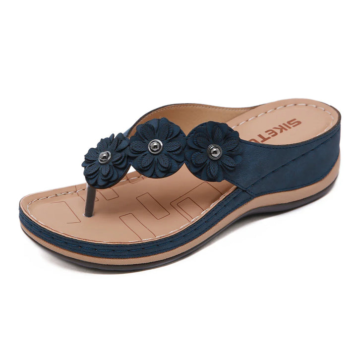 Women's navy blue wedge sandals with floral strap decoration and beige sole