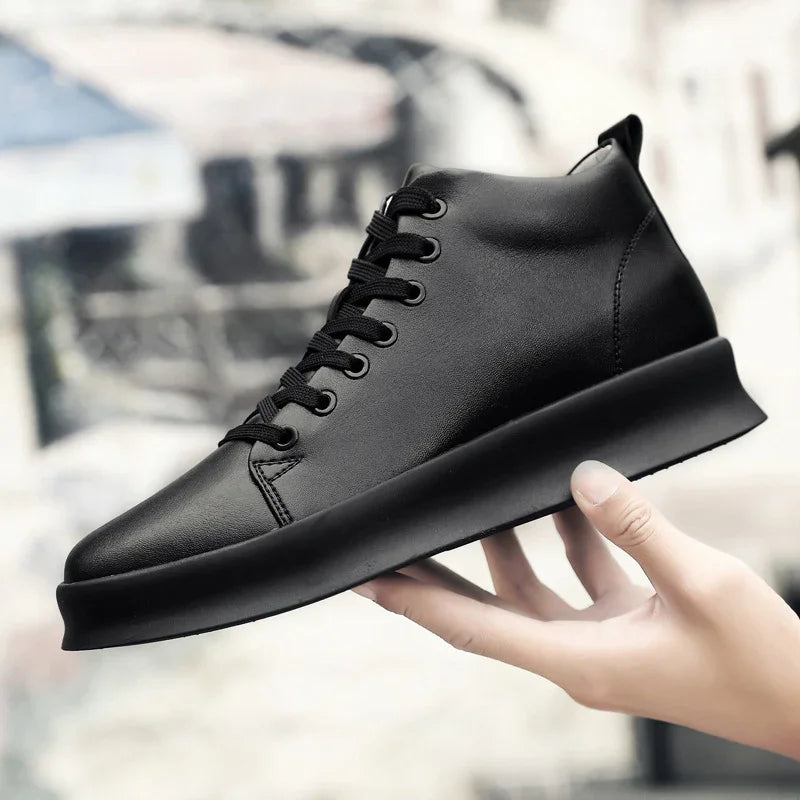Hand holding sleek black leather high-top sneaker with thick sole and black laces