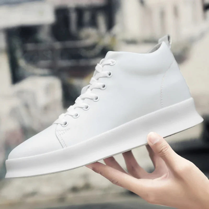 Hand holding minimalist white high-top casual sneaker with clean design