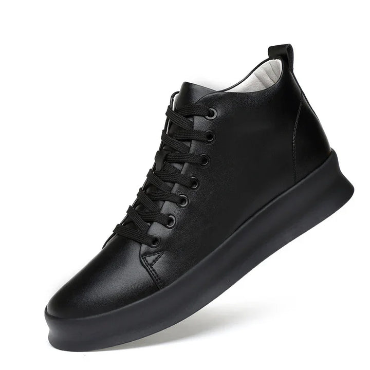 Black leather high-top sneaker with black laces and thick black sole on white background