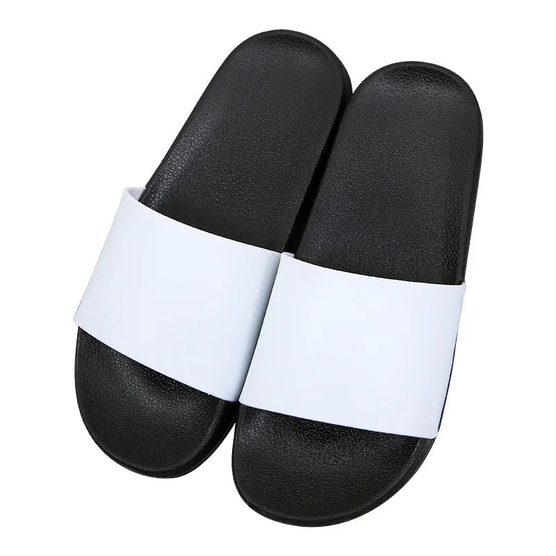 black slide sandals with wide white straps on white background