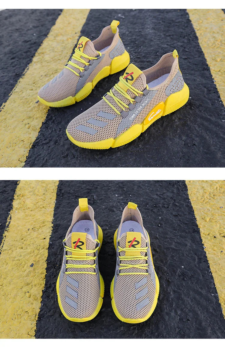 Lightweight beige and yellow breathable mesh running shoes with yellow soles and laces on asphalt with yellow road lines