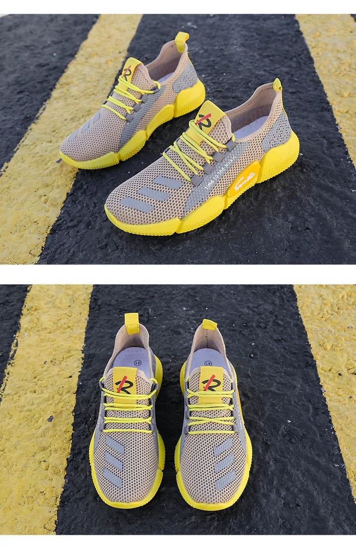 Lightweight beige and yellow breathable mesh running shoes with yellow soles and laces on asphalt with yellow road lines