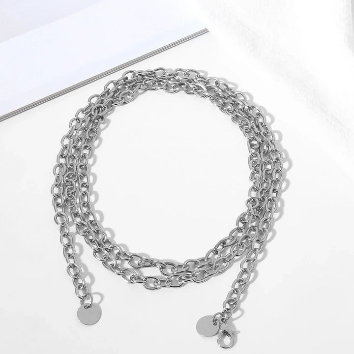 Silver chunky metal chain necklace with round pendants and lobster clasp on white background