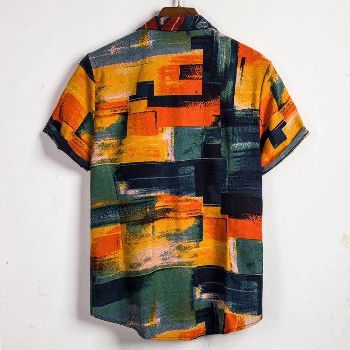 Back view of short sleeve shirt with abstract geometric orange, yellow, green, and black pattern