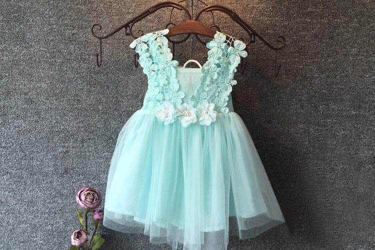 Light blue toddler dress with floral lace bodice and tulle skirt hanging on wooden hanger