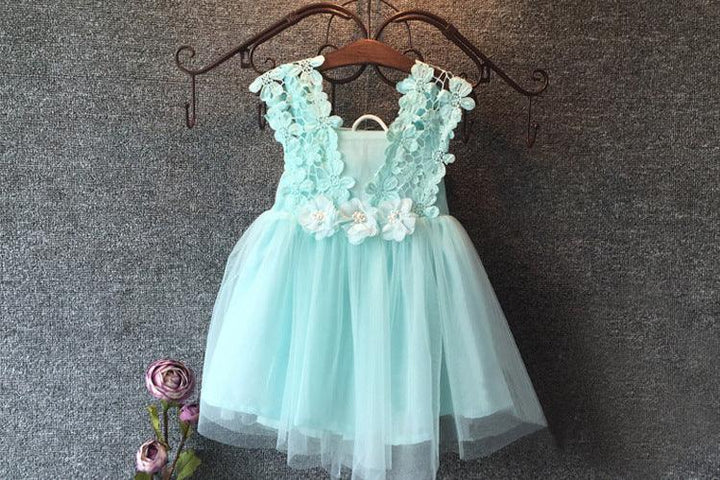 Light blue toddler dress with floral lace bodice and tulle skirt hanging on wooden hanger