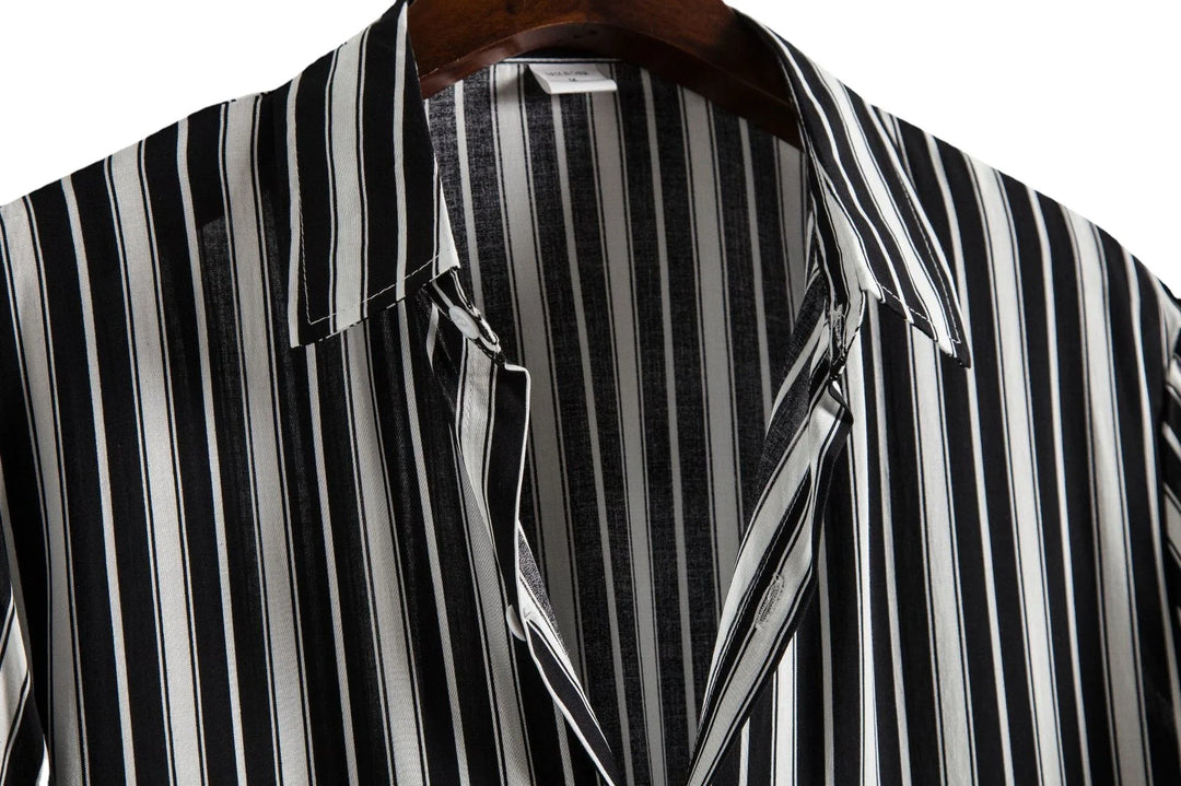 Black and white vertical striped button-up shirt on wooden hanger