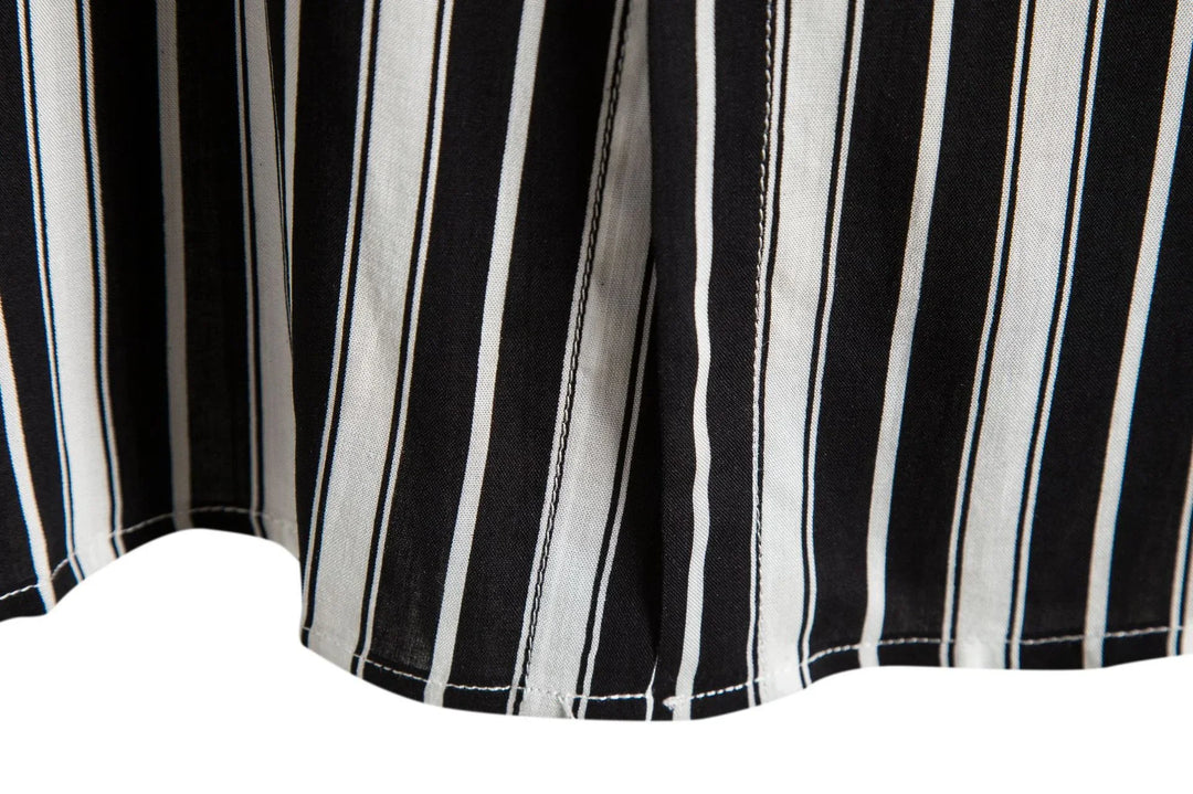 Black and white vertical striped fabric close-up with seam stitching detail