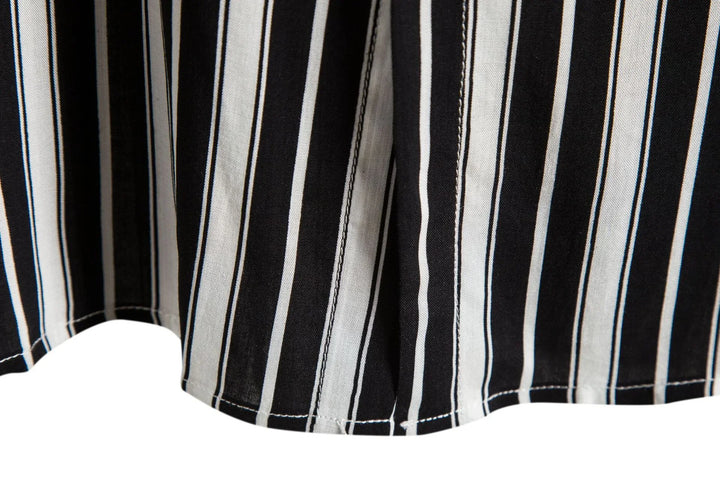 Black and white vertical striped fabric close-up with seam stitching detail