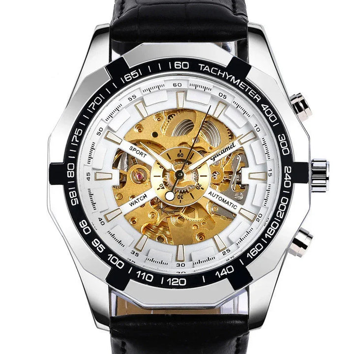 Silver automatic sport watch with gold skeleton dial, black tachymeter bezel, and black leather strap