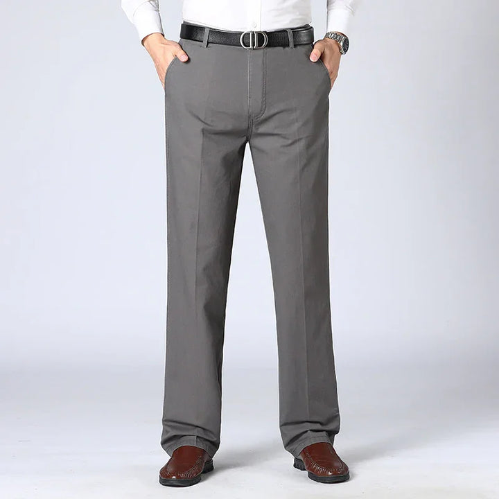 Men's gray formal trousers paired with black leather belt and brown leather shoes