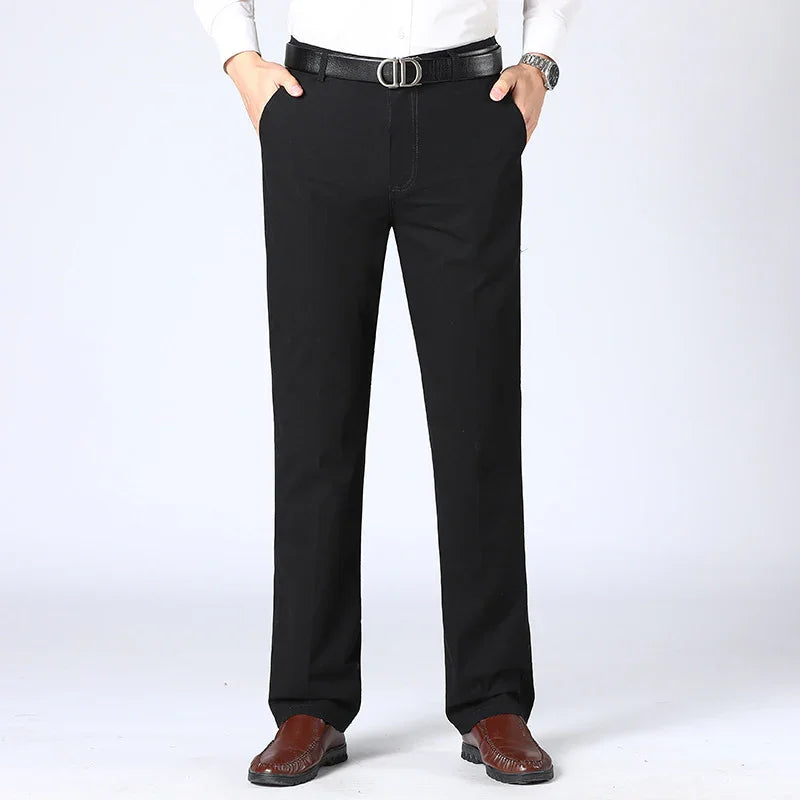 Man wearing black formal pants, brown leather shoes, black belt, and white shirt on white background