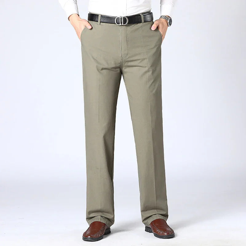 Man wearing olive green dress pants paired with brown leather loafers and a black belt