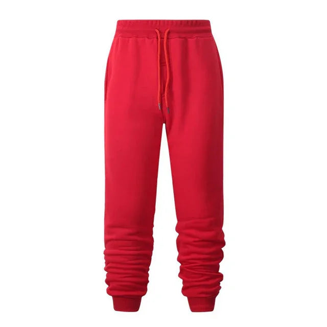 Bright red casual sweatpants with drawstring and elastic cuffs isolated on white