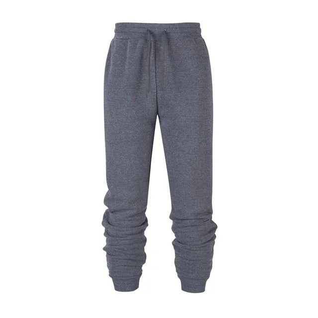 Men's grey jogger sweatpants with elastic waistband and cuffed ankles on white background