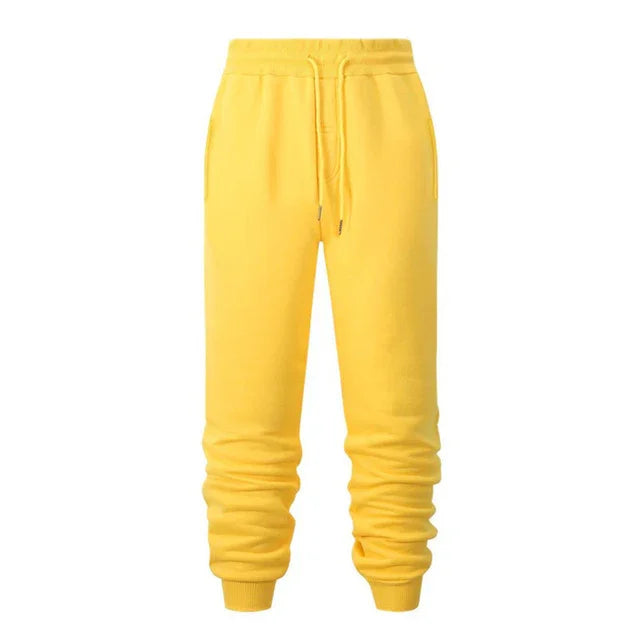 Bright yellow jogger pants with adjustable drawstring waist and ribbed cuffs