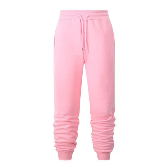 Pink women's jogger pants with elastic waistband and drawstring, ribbed cuffs, soft casual sweatpants