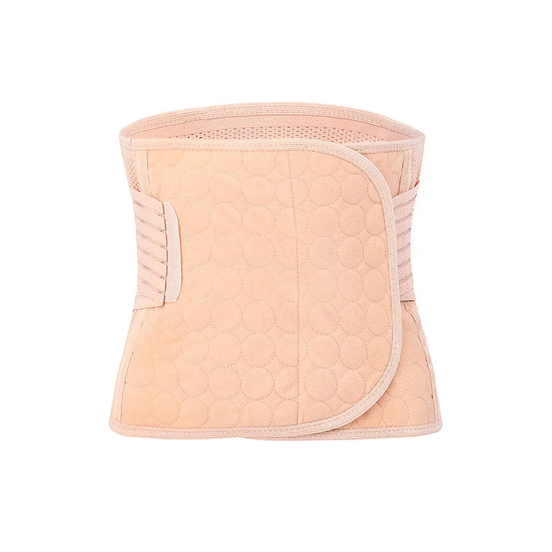Peach-colored quilted postpartum belly wrap with velcro closure on white background