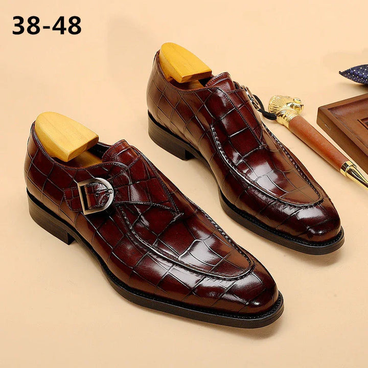 Brown crocodile pattern leather men's dress shoes with buckle detail and wooden shoe trees