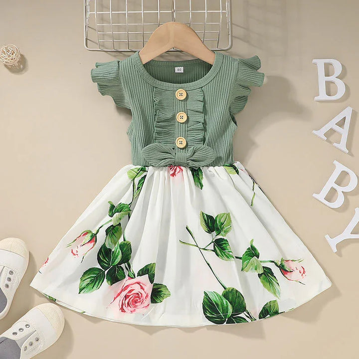 Green ribbed sleeveless baby dress with wooden buttons and white floral skirt with pink roses