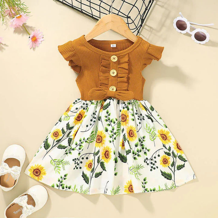 Toddler girl dress with brown ribbed top and sunflower print skirt, paired with white lace shoes and daisy sunglasses