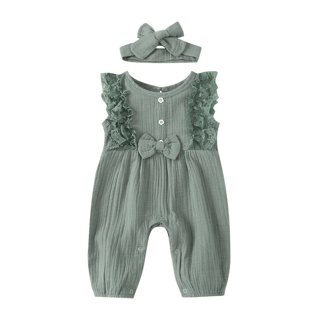 Green baby romper with lace ruffles, buttons, bow detail, and matching headband