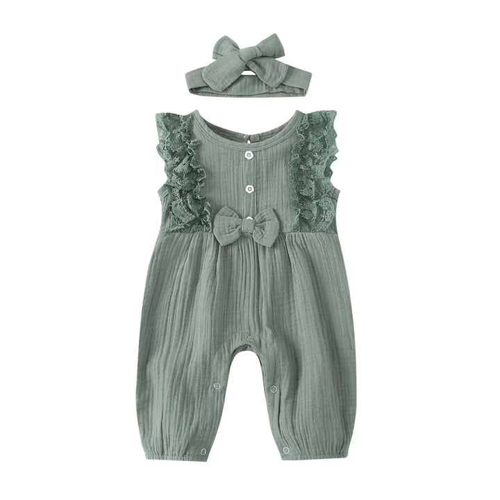 Green baby romper with lace ruffles, buttons, bow detail, and matching headband