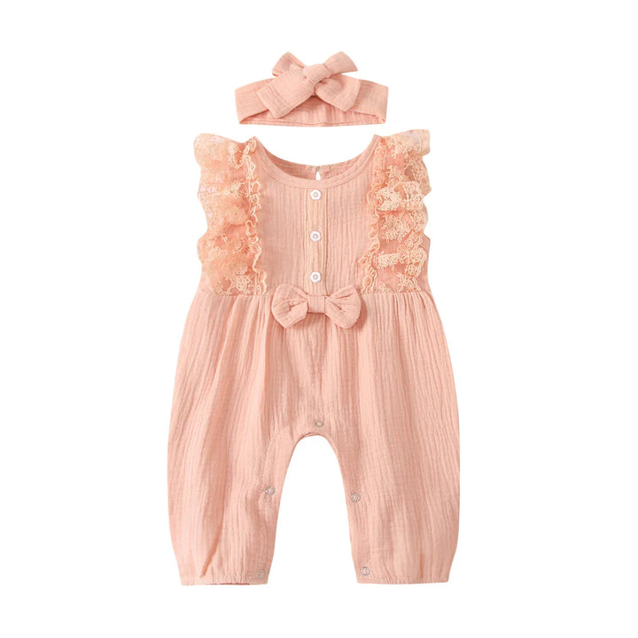 Pink baby romper with lace ruffles, buttons, bow detail, and matching headband