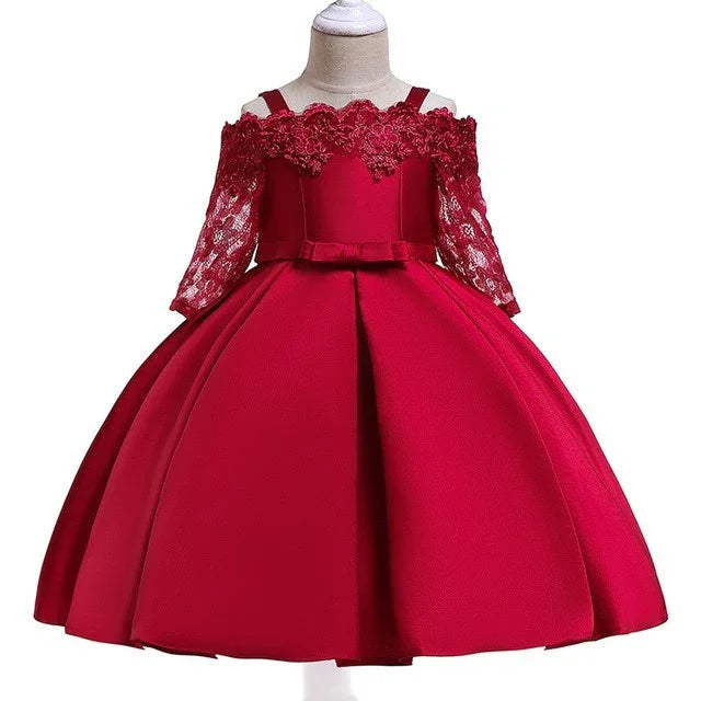Elegant red girl's party dress with lace sleeves, off-shoulder neckline, and bow detail on a mannequin