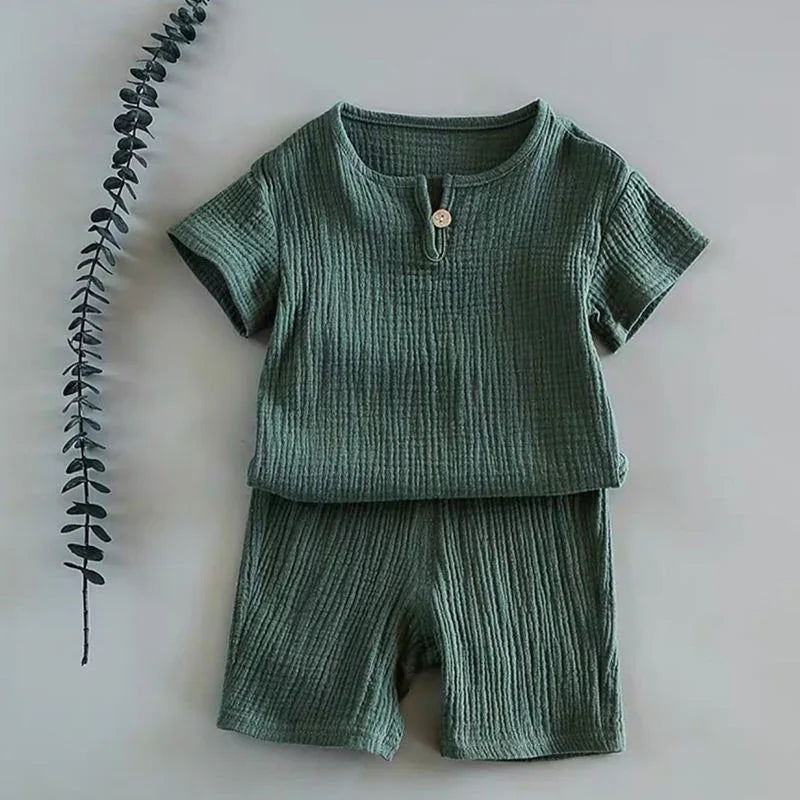 Green textured short-sleeve toddler outfit with button detail, paired with matching shorts