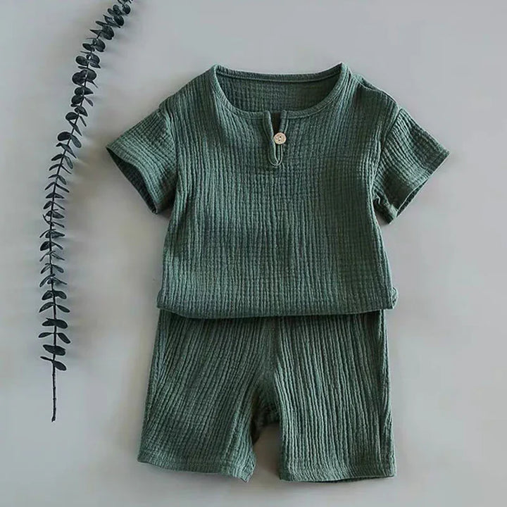 Green textured short-sleeve toddler outfit with button detail, paired with matching shorts