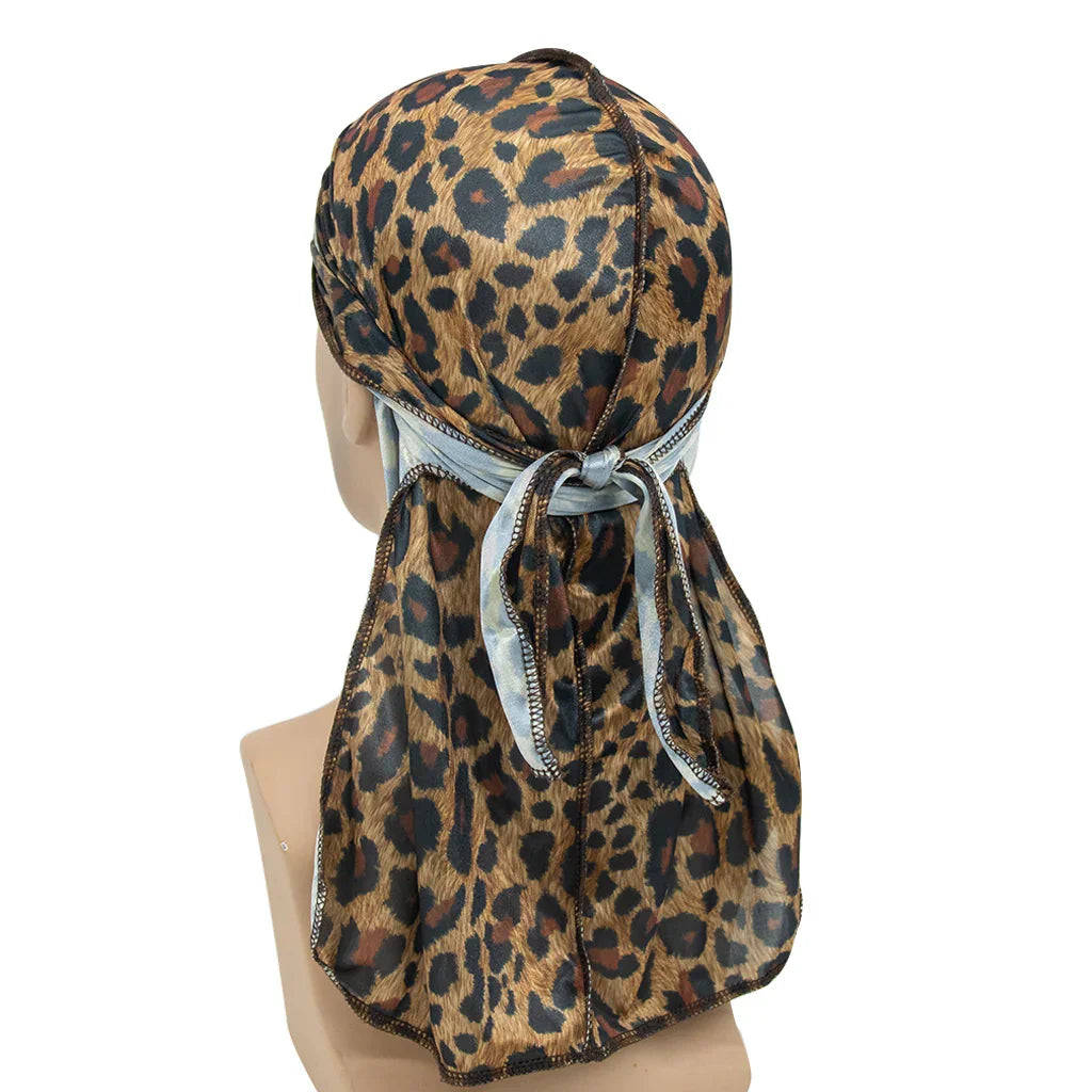 Leopard print silk durag with light blue tieback displayed on mannequin head