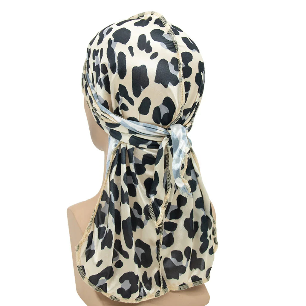 Leopard print satin durag with a tied back knot displayed on mannequin head