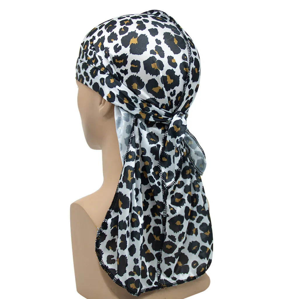 Leopard print silk durag tied at back on mannequin head with white background