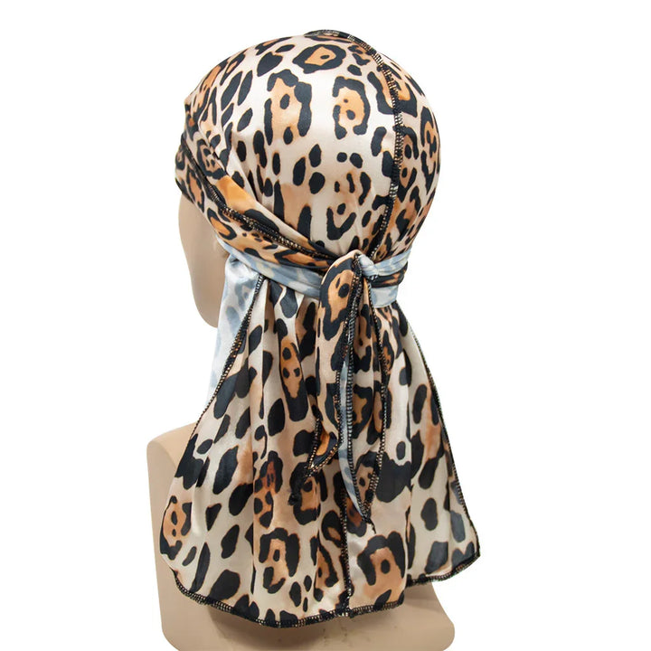 Leopard print satin durag with black stitching on mannequin head, tied at the back