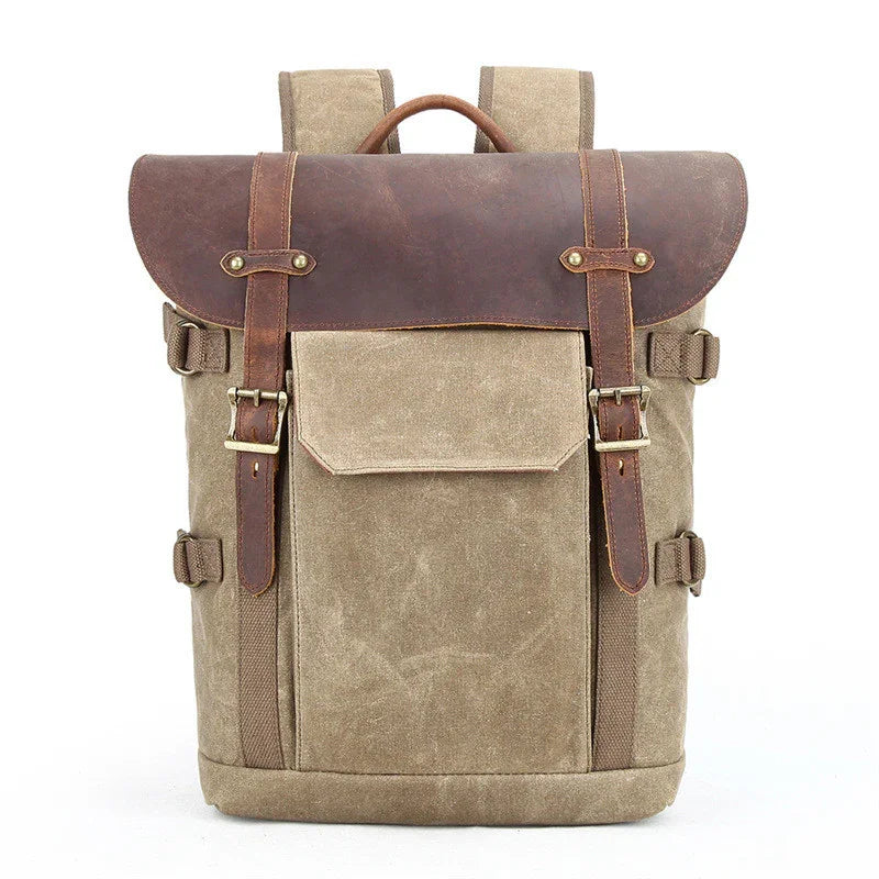 Vintage canvas backpack with brown leather flap, adjustable straps, and front pocket