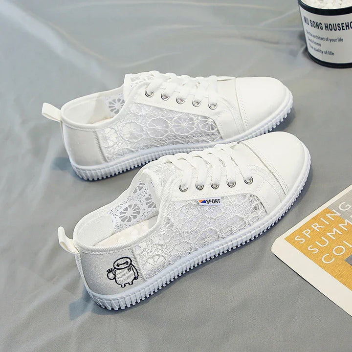 White lace casual sneakers with mesh design, laces, and cartoon angel embroidery on gray surface