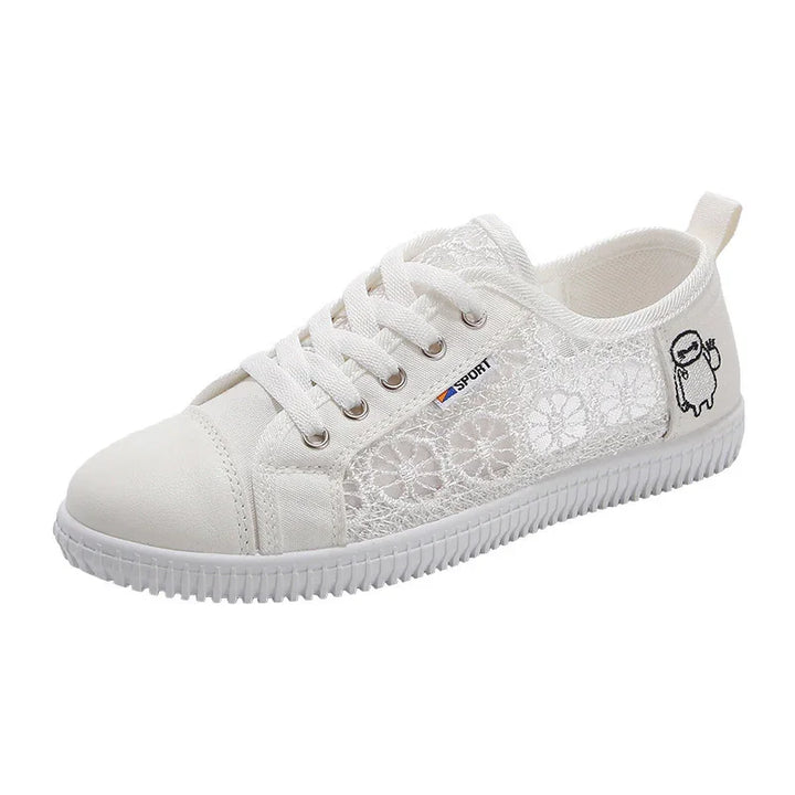 White lace pattern casual sneaker with white laces, rubber sole, and small cartoon patch on heel