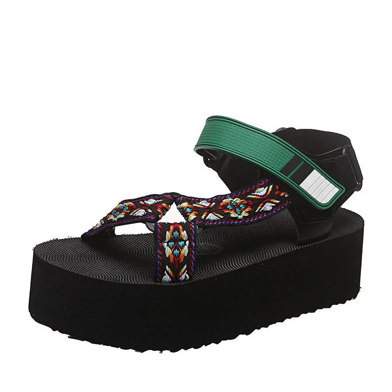 Black platform sandal with colorful woven straps and green adjustable ankle strap