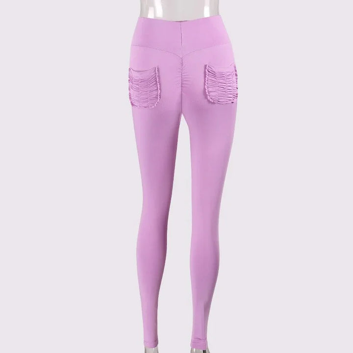 Back view of lilac high-waisted leggings with ruched square pockets on a mannequin