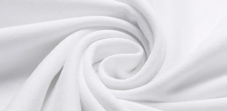 Close-up of soft white cotton fabric twisted in a spiral, showcasing texture and smoothness
