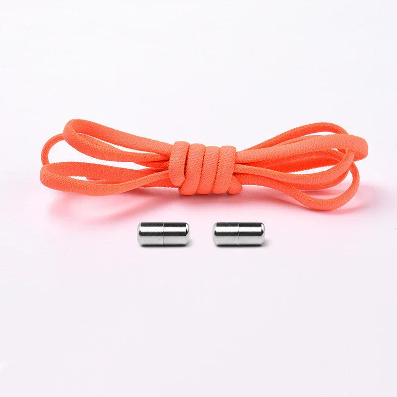 Orange elastic shoelace with two silver magnetic shoelace clasps on white background
