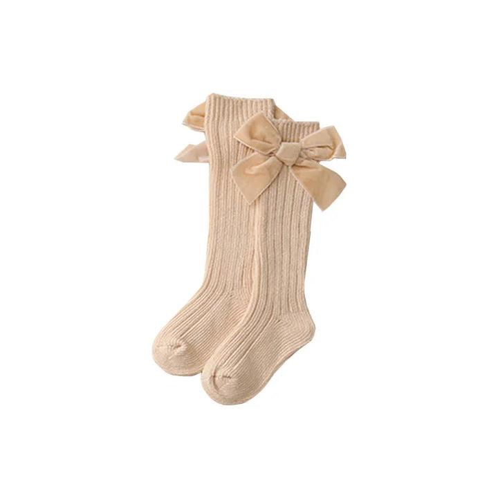 Beige ribbed knee-high socks for girls with large velvet bows on the sides