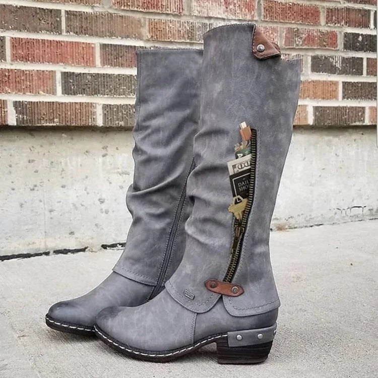 Gray knee-high leather boots with side zipper pocket holding cash and keys, stylish women's footwear