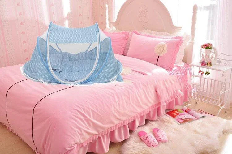 Blue baby mosquito net on pink bed with ruffled bedding in bright feminine bedroom