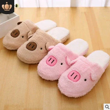 Cozy pink and brown pig-themed plush slippers on wooden floor