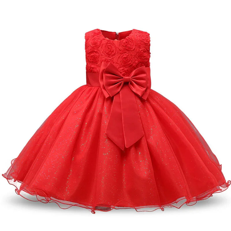 Elegant red girls' party dress with floral textured bodice, large bow, and glittery tulle skirt