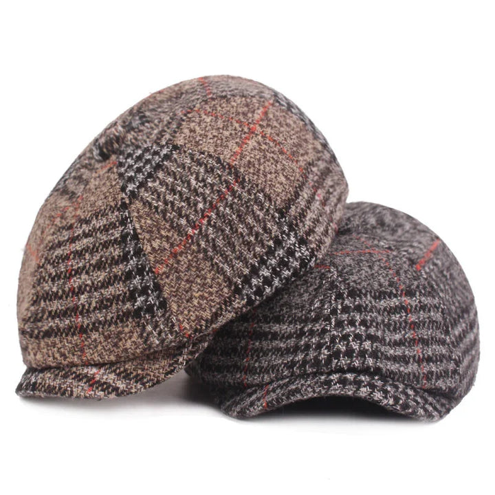 Two vintage flat caps with plaid pattern in brown and gray shades, featuring red and black lines